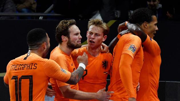 Netherlands' defender Virgil van Dijk celebrates with teammates after scoring against Germany.(AFP)