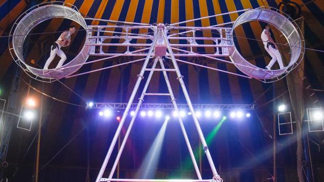 Artists performs a ‘wheel of death’ stunt at the Rambo circus in Mundhwa on Saturday. The wheel of death in the context of acrobatic circus arts, is a large rotating apparatus on which performers carry out synchronised acrobatic skills. The ‘wheel’ is actually a large space frame beam with hooped tracks at either end, within which the performers can stand. (SANKET WANKHADE/HT PHOTO) Artists performs a ‘wheel of death’ stunt at the Rambo circus in Mundhwa on Saturday. The wheel of death in the context of acrobatic circus arts, is a large rotating apparatus on which performers carry out synchronised acrobatic skills. The ‘wheel’ is actually a large space frame beam with hooped tracks at either end, within which the performers can stand. (SANKET WANKHADE/HT PHOTO)