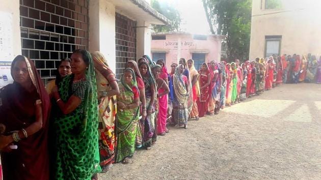 Women stand in a queue to cast their votes at a polling booth during the Assembly Election, in Banahil on November 20.(PTI Photo)