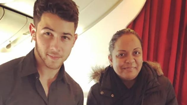 Nick Jonas poses with a fan, presumably on his way to India.