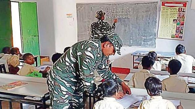 CRPF officials teaching students of Upgraded Middle School, Tholkobad, at Saranda in West Singhbhum district (Manoj Kumar/ HT Photo) CRPF officials teaching students of Upgraded Middle School, Tholkobad, at Saranda in West Singhbhum district (Manoj Kumar/ HT Photo)