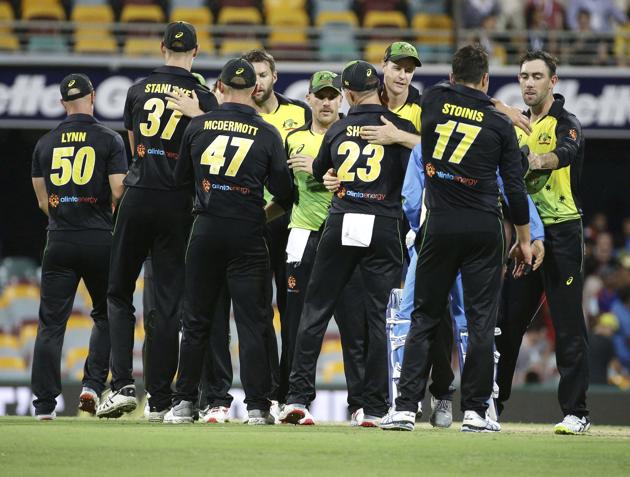 Australia players celebrate after winning the first T20 International cricket match between Australia and India in Brisbane, Australia. (AP)