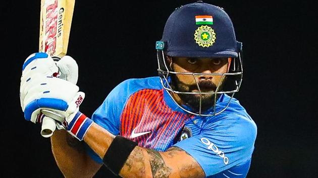 Virat Kohli hits a shot during the T20 international cricket match between Australia and India in Brisbane.(AFP)