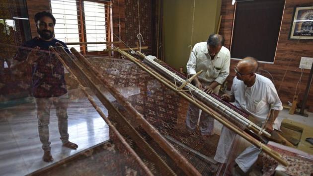 Two generations of a Salvi family work the loom to create the double ikat Patola, that is made only in this Gujarat town. If the Rani Ki Vav is the pride of Patan, the other thing that this little Gujarat town can claim to have a national monopoly over, is the double ikat silk weave. (Sanchit Khanna / HT Photo)