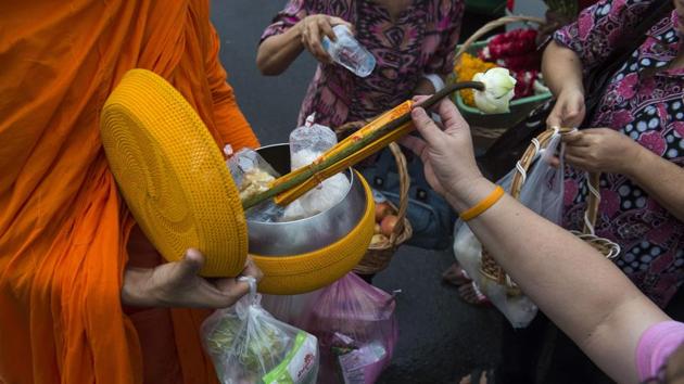 Thais seeking to earn merit and honour their ancestors often provide food to monks on their daily rounds but they can be generous to a fault. Heavy curries, sugary sweets, sodas and salty snacks are among the array of sumptuous -- and unhealthy -- alms. (Romeo Gacad / AFP) Thais seeking to earn merit and honour their ancestors often provide food to monks on their daily rounds but they can be generous to a fault. Heavy curries, sugary sweets, sodas and salty snacks are among the array of sumptuous -- and unhealthy -- alms. (Romeo Gacad / AFP)