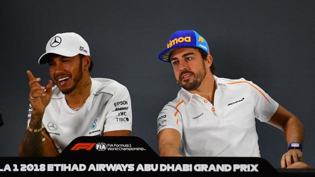 McLaren's Spanish driver Fernando Alonso (R) and Mercedes' British driver Lewis Hamilton speak as they attend the drivers' press conference ahead of the Abu Dhabi Formula One Grand Prix at the Yas Marina circuit on November 22, 2018.(AFP)