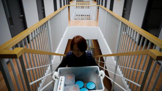 An administrator serves meals. The menu includes steamed sweet potato and a banana shake for dinner, and rice porridge for breakfast. Co-founder Noh Ji-Hyang said the mock prison was inspired by her husband, a prosecutor who often put in 100-hour work weeks. (Kim Hong-Ji / REUTERS) An administrator serves meals. The menu includes steamed sweet potato and a banana shake for dinner, and rice porridge for breakfast. Co-founder Noh Ji-Hyang said the mock prison was inspired by her husband, a prosecutor who often put in 100-hour work weeks. (Kim Hong-Ji / REUTERS)
