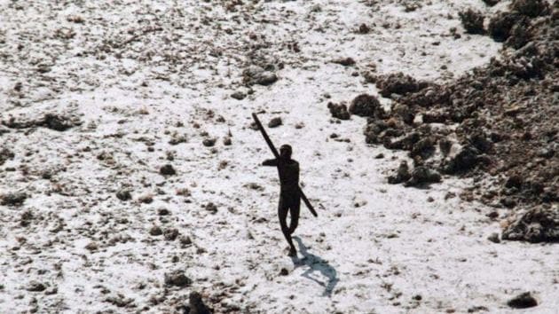In this handout photo provided by the Indian Coast Guard and Survival International and taken on December 28, 2004, a man with the Sentinelese tribe aims his bow and arrow at an Indian Coast Guard helicopter as it flies over North Sentinel Island in the Andaman Islands.(AFP)