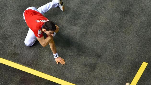 Altuna III returns the ball during the Euskolabel eusko pilota (barehand pelota) 4 1/2 championship final match between Altuna III and Ezkurdia at the Navarra arena in Pamplona, Spain. (Ander Gillenea / AFP) Altuna III returns the ball during the Euskolabel eusko pilota (barehand pelota) 4 1/2 championship final match between Altuna III and Ezkurdia at the Navarra arena in Pamplona, Spain. (Ander Gillenea / AFP)