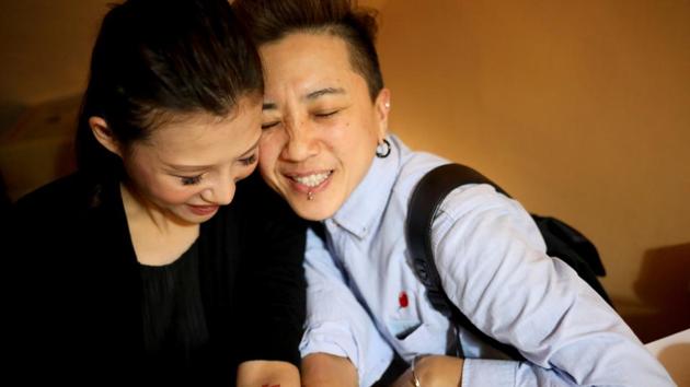 Du Yueting (R), 42, and her girlfriend Zhang Tongyu, 35, pose at their restaurant after a long day of work, in New Taipei City. In Asia’s first such ruling, Taiwan’s constitutional court declared in May last year that same-sex couples had the right to legally marry, and set a two-year deadline for legalisation. (Ann Wang / REUTERS)