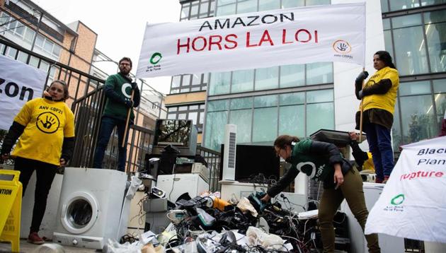 Activists of French NGOs 'Les Amis de la Terre' (Friends of the Earth) and ANV Cop21 dump trashed appliances in front of the French headquarters of US online retailer Amazon on November 23, 2018 in Clichy, northwest of Paris, during a protest against the company and on the first day of the Black Friday sales. (AFP) Activists of French NGOs 'Les Amis de la Terre' (Friends of the Earth) and ANV Cop21 dump trashed appliances in front of the French headquarters of US online retailer Amazon on November 23, 2018 in Clichy, northwest of Paris, during a protest against the company and on the first day of the Black Friday sales. (AFP)