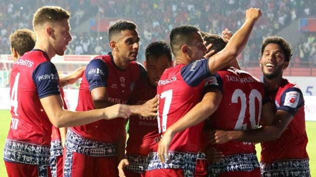 Jamshedpur: Players of Jamshedpur FC (Red jersey) celebrate after scoring a goal against ATK, Kolkata (Black-Grey jersey) during the Indian Super League (ISL) football match(PTI)