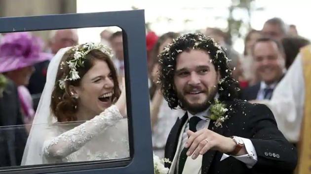 Actors Kit Harington and Rose Leslie react as they leave after their wedding ceremony at Rayne Church, Scotland on Saturday.(AP)(AP)