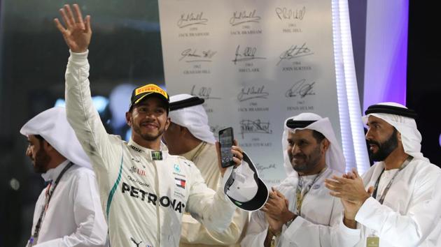 Mercedes' Lewis Hamilton celebrates winning the race on the podium.(REUTERS)