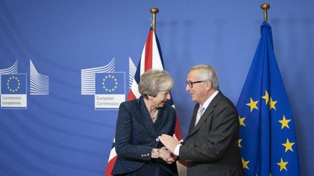 Theresa May, U.K. prime minister, left, reacts as she shakes hands with Jean-Claude Juncker, president of the European Commission, during a meeting ahead of Brexit negotiations in the Berlaymont building in Brussels, Belgium. (Bloomberg) Theresa May, U.K. prime minister, left, reacts as she shakes hands with Jean-Claude Juncker, president of the European Commission, during a meeting ahead of Brexit negotiations in the Berlaymont building in Brussels, Belgium. (Bloomberg)
