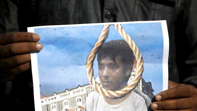 A man holds a picture of Mohammad Ajmal Kasab with a noose, as he celebrates Kasab's execution.(Reuters file photo)