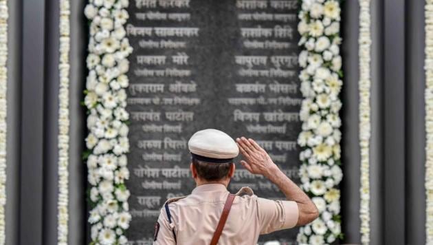 A Mumbai Police personnel pays tribute to martyrs of the 26/11 terror attacks on its tenth anniversary at the Martyrs’ Memorial, Police Gymkhana in Mumbai. On November 26, 2008, 10 Pakistani terrorists arrived by sea route and opened fire indiscriminately, killing 166, including 18 security personnel, and injuring several others, besides damaging property worth crores. (Kunal Patil / HT Photo) A Mumbai Police personnel pays tribute to martyrs of the 26/11 terror attacks on its tenth anniversary at the Martyrs’ Memorial, Police Gymkhana in Mumbai. On November 26, 2008, 10 Pakistani terrorists arrived by sea route and opened fire indiscriminately, killing 166, including 18 security personnel, and injuring several others, besides damaging property worth crores. (Kunal Patil / HT Photo)