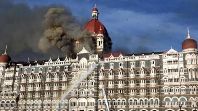 Smoke billows as fire brigade officers try to douse the fire at the Taj Hotel in Mumbai on November 27, 2008.(HT File Photo)