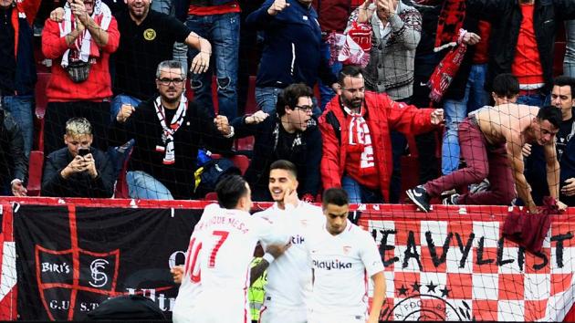 Sevilla's Portuguese forward Andre Silva (centre) celebrates after scoring during the match against Real Valladolid.(AFP)