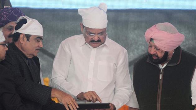 Vice President M Venkaiah Naidu (C), Punjab chief minister Amarinder Singh (R) and Union minister of Road Transport and Highway Nitin Gadkari (2L) officiate the foundation stone-laying ceremony for the planned Dera Baba Nanak-Kartarpur Sahib road corridor to the Pakistan border, at Dera Baba Nanak, on the outskirts of Amritsar on November 26. (AFP Photo) Vice President M Venkaiah Naidu (C), Punjab chief minister Amarinder Singh (R) and Union minister of Road Transport and Highway Nitin Gadkari (2L) officiate the foundation stone-laying ceremony for the planned Dera Baba Nanak-Kartarpur Sahib road corridor to the Pakistan border, at Dera Baba Nanak, on the outskirts of Amritsar on November 26. (AFP Photo)