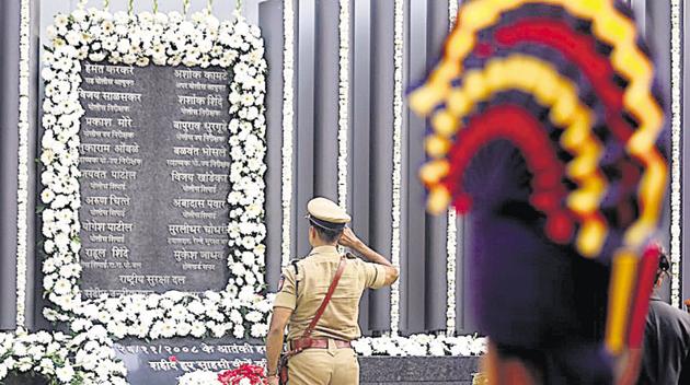 A policeman pays his respects at a 26/11 memorial on the 10th anniversary of the attacks, in Mumbai on Monday.(Reuters Photo) A policeman pays his respects at a 26/11 memorial on the 10th anniversary of the attacks, in Mumbai on Monday.(Reuters Photo)