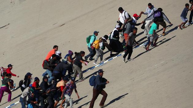 Migrants, part of a caravan of thousands from Central America trying to reach the United States, make their way to the border fence between Mexico and the United States in Tijuana, Mexico on November 25, 2018.(REUTERS)