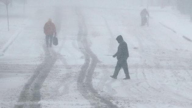 The National Weather Service said in an advisory that travel on Monday morning will be “very dangerous to impossible” and the heavy snow was difficult to shovel and may cause falling tree limbs and power outages.(AP)