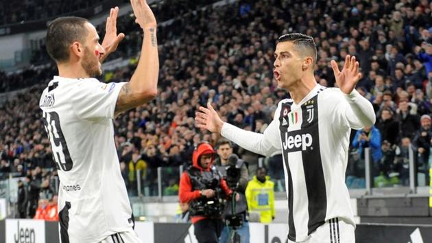 Juventus' Cristiano Ronaldo celebrates scoring their first goal with Leonardo Bonucci(REUTERS) Juventus' Cristiano Ronaldo celebrates scoring their first goal with Leonardo Bonucci(REUTERS)