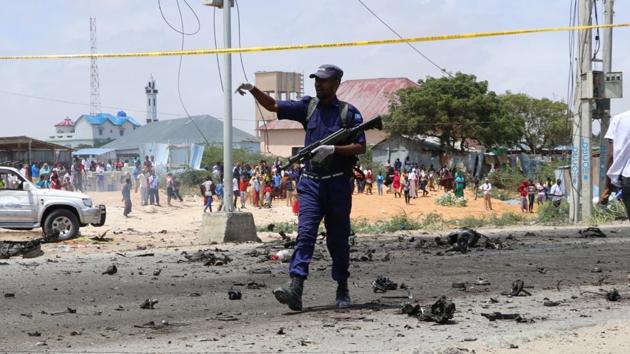 A Somalia police officer secures the scene of a suicide bomb attack. (Representational Photo)(AFP)