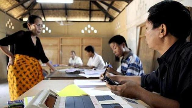 Election Commission official administers voting papers at a polling station at Bungthuam, on the outskirts of Aizwal, in Mizoram.(AFP Photo)