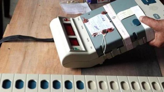 Election Commission officials seal an Electronic Voting Machine (EVM) prior to the start of voting at a polling station in Dibrugarh, Assam.(AFP File Photo)