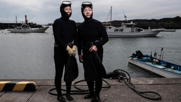 Hashimoto Michiko (L), 66, and Koguchi Hideko, 62, pose for a photograph. Only 2,000 ama are left across Japan, down from more than 12,000 in the 1930s, according to records kept by a marine museum in Toba. The profession still exists in South Korea, where the divers are known as haenyo, but their numbers are also shrinking. (Martin Bureau / AFP)