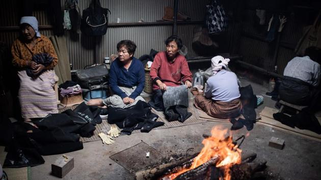 The women, some bent over with age, acknowledge the work is poorly paid and dangerous. “Of course I would love the kids to take over, but I know that being an ama diver is a difficult job and I don’t recommend it, even to my own children,” says Koguchi’s sister Michiko Hashimoto warming herself up around a fire in a the hut where the women gather to recharge. (Martin Bureau / AFP)