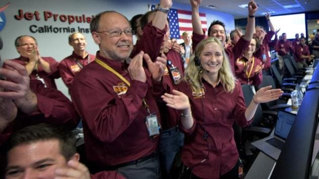 InSight team members celebrate after the successful landing.(Reuters)