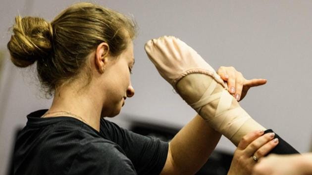 An instructor helps a student’s pose during a class at a ballet studio in Moscow. “We (the teachers) are all professionals from these academies and theatres and we safeguard these traditions,” she said. (Mladen Antonov / AFP) An instructor helps a student’s pose during a class at a ballet studio in Moscow. “We (the teachers) are all professionals from these academies and theatres and we safeguard these traditions,” she said. (Mladen Antonov / AFP)