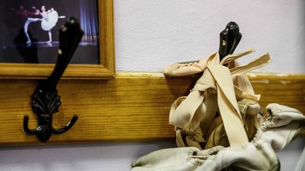 A pair of pointe shoes hangs on the wall at a ballet studio in Moscow. The studio is one of dozens in the Russian capital, home to some of the world’s best ballet troupes. Many are run by former professional ballerinas. Children and teenagers meet at the studio in a Soviet-era community centre three times a week for classical ballet classes. (Mladen Antonov / AFP) A pair of pointe shoes hangs on the wall at a ballet studio in Moscow. The studio is one of dozens in the Russian capital, home to some of the world’s best ballet troupes. Many are run by former professional ballerinas. Children and teenagers meet at the studio in a Soviet-era community centre three times a week for classical ballet classes. (Mladen Antonov / AFP)