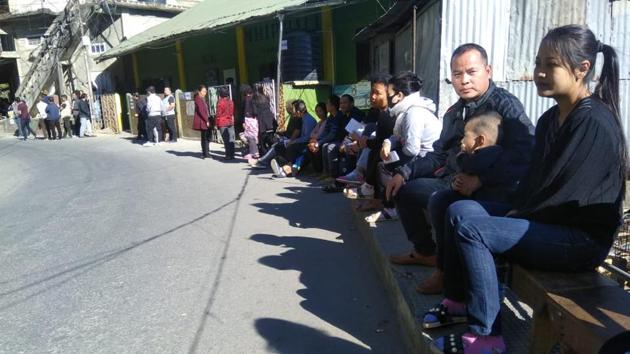 Voters wait outside a polling booth in Aizawl South. Unlike many other states, provision is made for voters to sit outside polling booths while waiting for their turn.