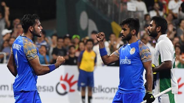 File image of India's Harmanpreet Singh (L) and Manpreet Singh (R) celebrating a goal.(AFP)