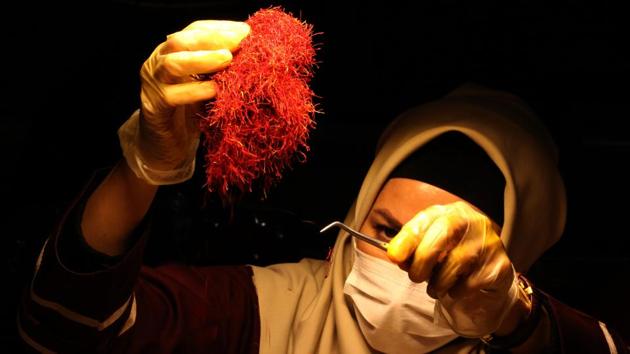 A worker sorts and cleans saffron filaments. Other issues are forcing innovation on the industry -- most pressingly, the drought that has hit Iran’s dry regions for the past two decades. Saffron requires much less water than other crops, but the drought is still causing a migration northwards. (Atta Kenare / AFP) A worker sorts and cleans saffron filaments. Other issues are forcing innovation on the industry -- most pressingly, the drought that has hit Iran’s dry regions for the past two decades. Saffron requires much less water than other crops, but the drought is still causing a migration northwards. (Atta Kenare / AFP)