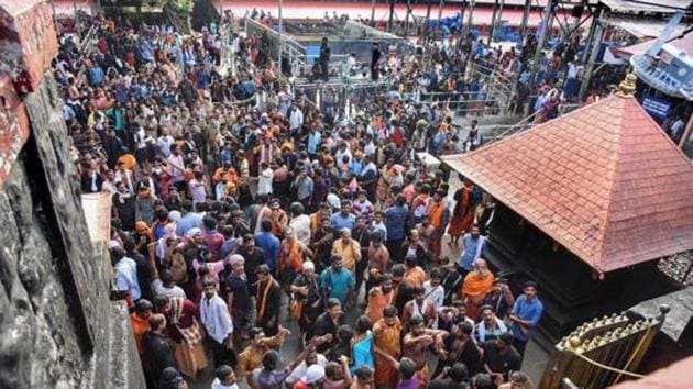 Hindu devotees stage a protest at Sabarimala temple after a woman who reached near the 18 holy steps of the hilltop shrine was heckled by agitators over her age, at Sabarimala, in Pathanamthitta district(PTI File Photo)