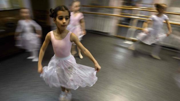 In a small studio in northern Moscow, girls as young as three in tutus and pointe shoes practise their ballet moves in front of a mirror. Lined up on their mats, the youngsters have no difficulty stretching their legs up over their heads -- let alone doing splits. (Mladen Antonov / AFP) In a small studio in northern Moscow, girls as young as three in tutus and pointe shoes practise their ballet moves in front of a mirror. Lined up on their mats, the youngsters have no difficulty stretching their legs up over their heads -- let alone doing splits. (Mladen Antonov / AFP)