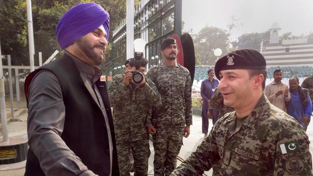 Pakistan Rangers personnel greet Punjab tourism minister Navjot Singh Sidhu as he crosses over to Pakistan through the Wagah border, Tuesday, Nov 27, 2018 to attend the groundbreaking ceremony of the Kartarpur Corridor at Nankana Sahib.(PTI)