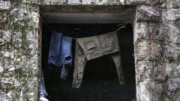 Clothes hang from a rope at a window of a shelter. Some migrants wear only worn-out shoes and no socks as they line up to receive a hot meal from aid groups helping out in the Borici camp, a former student dormitory damaged during the war. (Amel Emric / AP) Clothes hang from a rope at a window of a shelter. Some migrants wear only worn-out shoes and no socks as they line up to receive a hot meal from aid groups helping out in the Borici camp, a former student dormitory damaged during the war. (Amel Emric / AP)