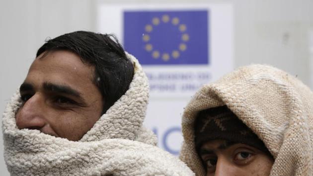 Migrants keep warm at a shelter in Bihac. The narrow road winds up the Pljesivica mountain through the forest and migrants must walk for hours before they reach the Croatian border. With the weather worsening in the past several days, migrants now face snow and freezing temperatures on their trek, setting off in the afternoon to reach the border in the dark. (Amel Emric / AP) Migrants keep warm at a shelter in Bihac. The narrow road winds up the Pljesivica mountain through the forest and migrants must walk for hours before they reach the Croatian border. With the weather worsening in the past several days, migrants now face snow and freezing temperatures on their trek, setting off in the afternoon to reach the border in the dark. (Amel Emric / AP)