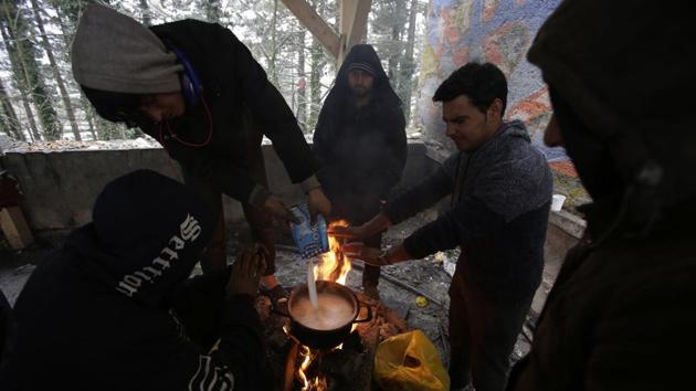 Migrants prepare food by a fire at a shelter in Bihac. Thousands of migrants from the Middle East, Africa or Asia have been flocking to northwestern Bosnia for the crossing, and many must try several times before they manage to slip past the border police. (Amel Emric / AP) Migrants prepare food by a fire at a shelter in Bihac. Thousands of migrants from the Middle East, Africa or Asia have been flocking to northwestern Bosnia for the crossing, and many must try several times before they manage to slip past the border police. (Amel Emric / AP)