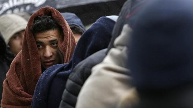 Migrants wrapped in blankets wait for food distribution. Nur Rahman, also from Afghanistan, agrees the situation is “very difficult” and says the migrants need more clothes and medicine. But he says they won’t give up their quest to reach the EU. “We are planning to cross the mountain, even if it’s minus 50 every day,” he said. (Amel Emric / AP) Migrants wrapped in blankets wait for food distribution. Nur Rahman, also from Afghanistan, agrees the situation is “very difficult” and says the migrants need more clothes and medicine. But he says they won’t give up their quest to reach the EU. “We are planning to cross the mountain, even if it’s minus 50 every day,” he said. (Amel Emric / AP)