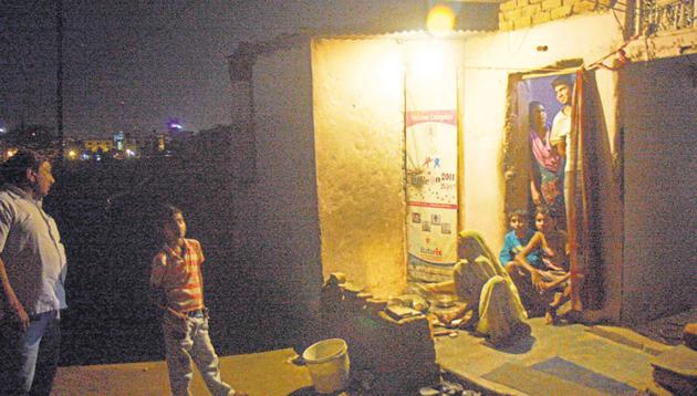 A family in the light of a bulb in a slum. Image for representation.(HT file photo)