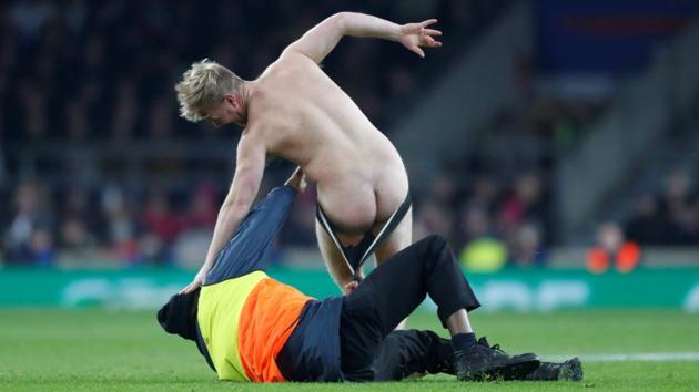 A pitch invader is tackled by a steward during an England v Australia rugby match at Twickenham Stadium in London, England. (Paul Childs / Action Images via Reuters) A pitch invader is tackled by a steward during an England v Australia rugby match at Twickenham Stadium in London, England. (Paul Childs / Action Images via Reuters)