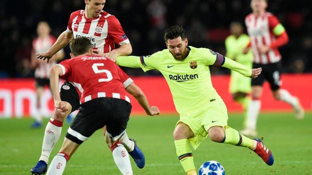 Eindhoven's defender Daniel Schwaab (left) vies with Barcelona's Lionel Messi (right) during their Champions League match.(AFP)