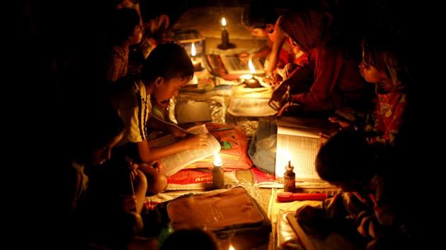 Students read their books and write under kerosene oil lamps on Ghoramara Island. Residents say the flood waters are getting worse, threatening their homes and livelihoods. (Rupak De Chowdhuri / REUTERS) Students read their books and write under kerosene oil lamps on Ghoramara Island. Residents say the flood waters are getting worse, threatening their homes and livelihoods. (Rupak De Chowdhuri / REUTERS)